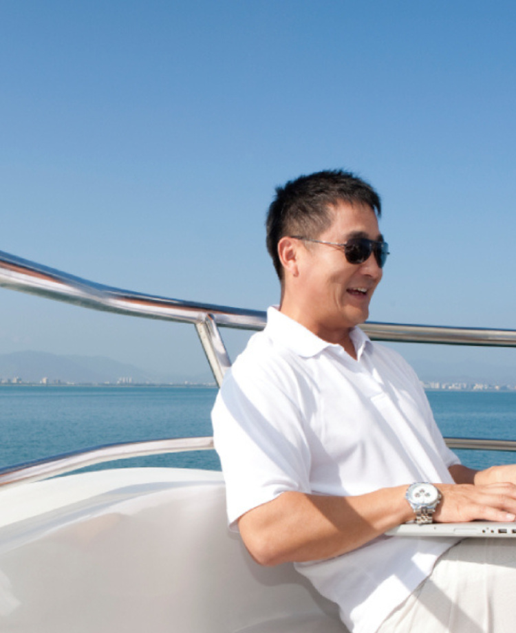 man using laptop on a boat