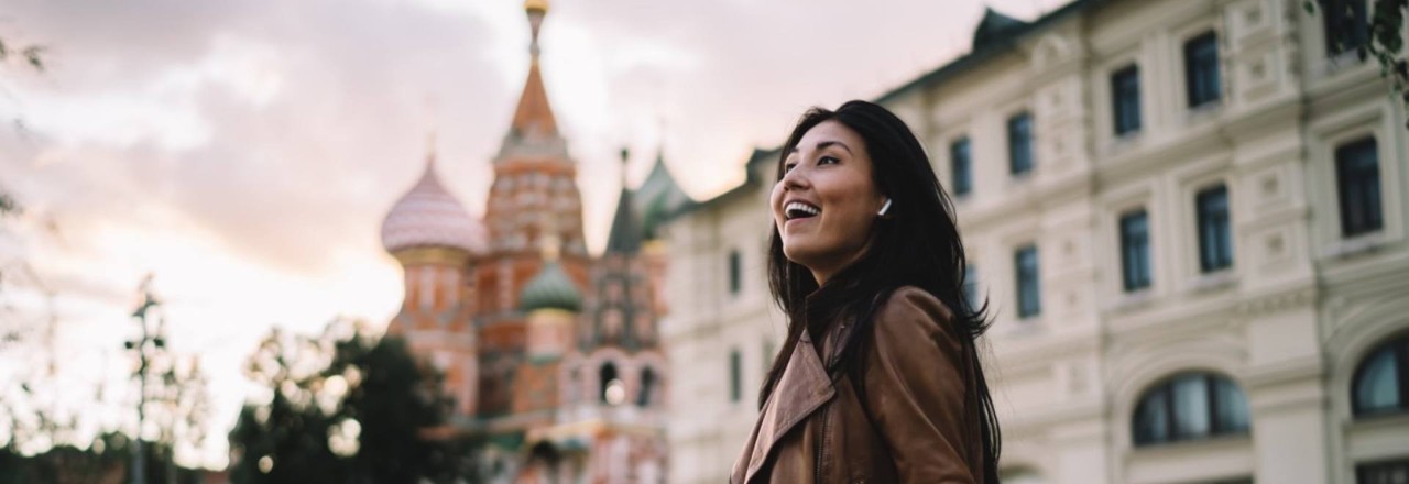 girl wearing brown jacket exploring city