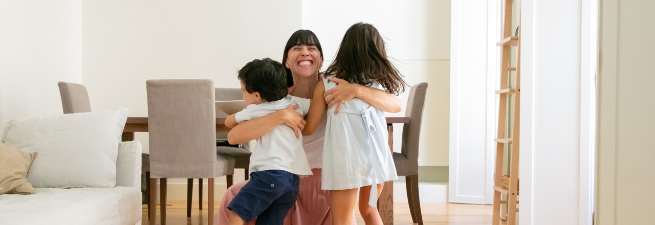 mother hugging her two kids
